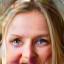 Smiling woman, late 40s, professional and healthy appearance.